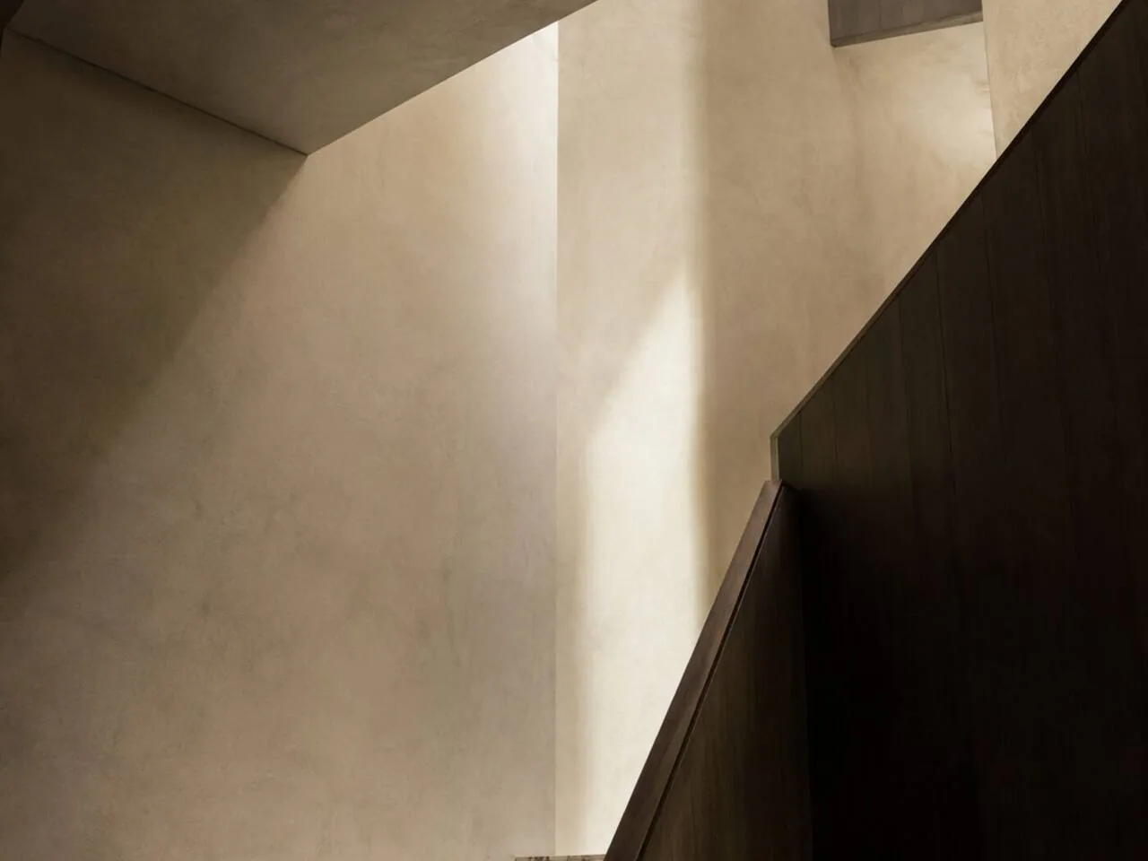 An architectural fold where two planes meet in raking light